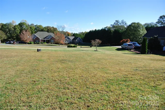 a view of a field with trees in the background