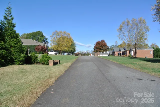 a view of a street with a house in the background