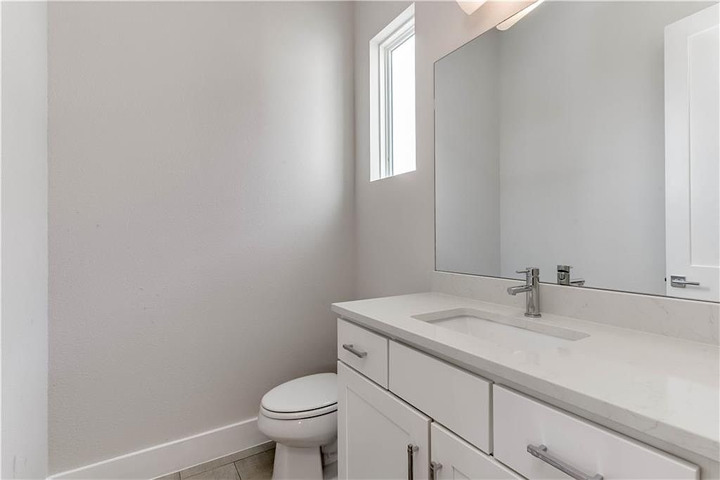 5002 Pecan Springs Road, Unit 10 Austin, TX 78723 - Photo 20 of 29 Bathroom featuring tile patterned floors, toilet, vanity, and baseboards