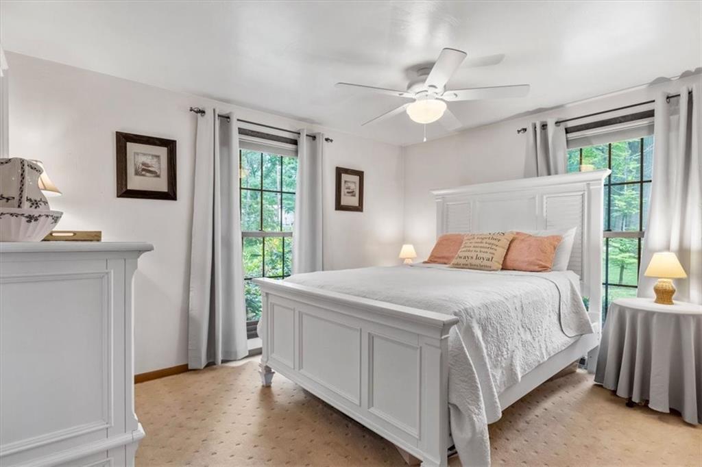 206 Ridgeway Drive Baden, PA 15005 - Photo 14 of 25 a bedroom with a large bed and a chandelier