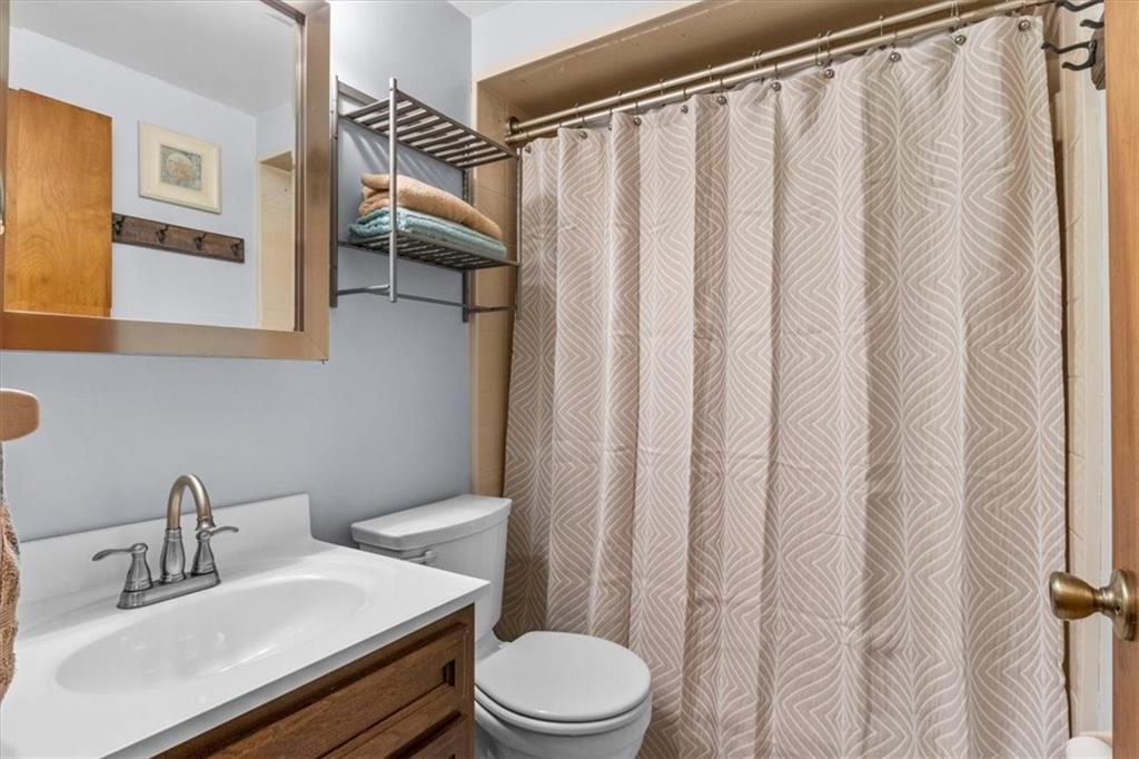206 Ridgeway Drive Baden, PA 15005 - Photo 15 of 25 a bathroom with a sink a toilet and shower curtain