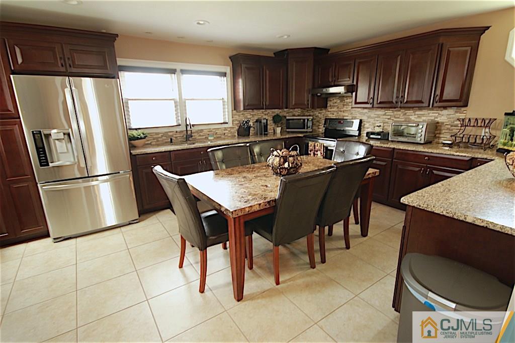 179 Midfield Road Colonia, NJ 07067 - Photo 2 of 18 a kitchen with stainless steel appliances granite countertop a sink a stove a refrigerator and cabinets