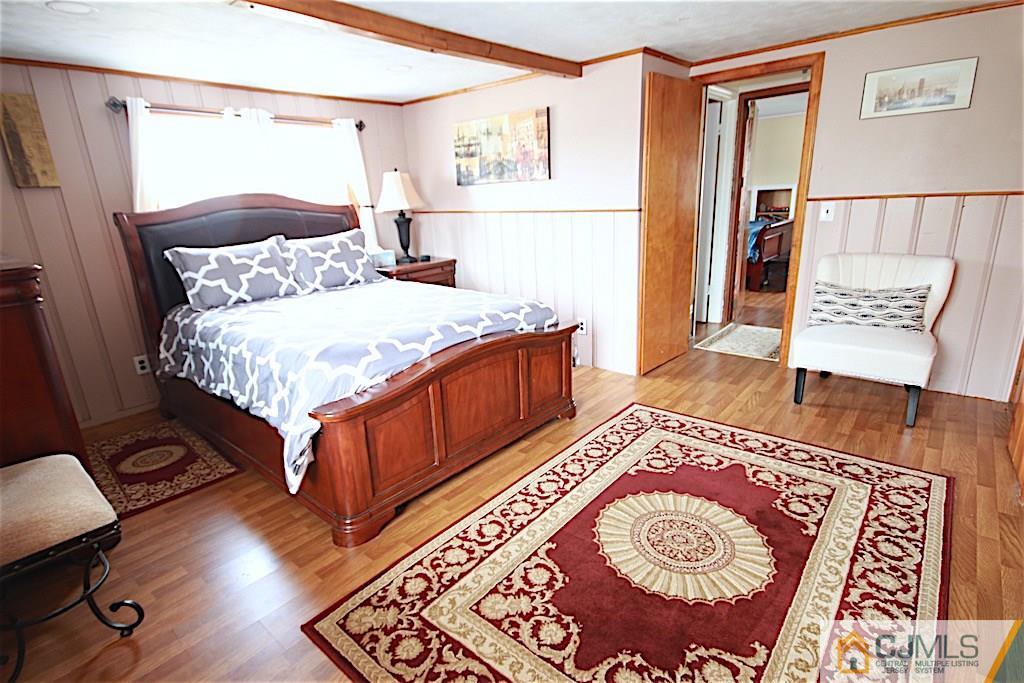 179 Midfield Road Colonia, NJ 07067 - Photo 11 of 18 a bedroom with a bed and a table in it