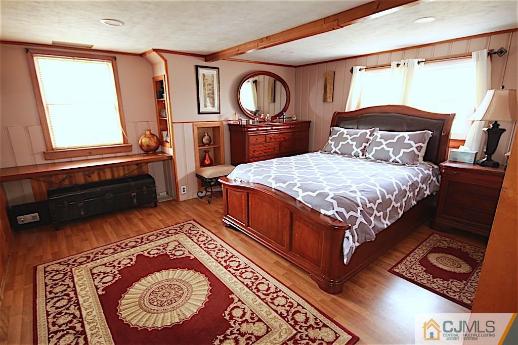179 Midfield Road Colonia, NJ 07067 - Photo 12 of 18 a bedroom with a bed and a dresser with wooden floor