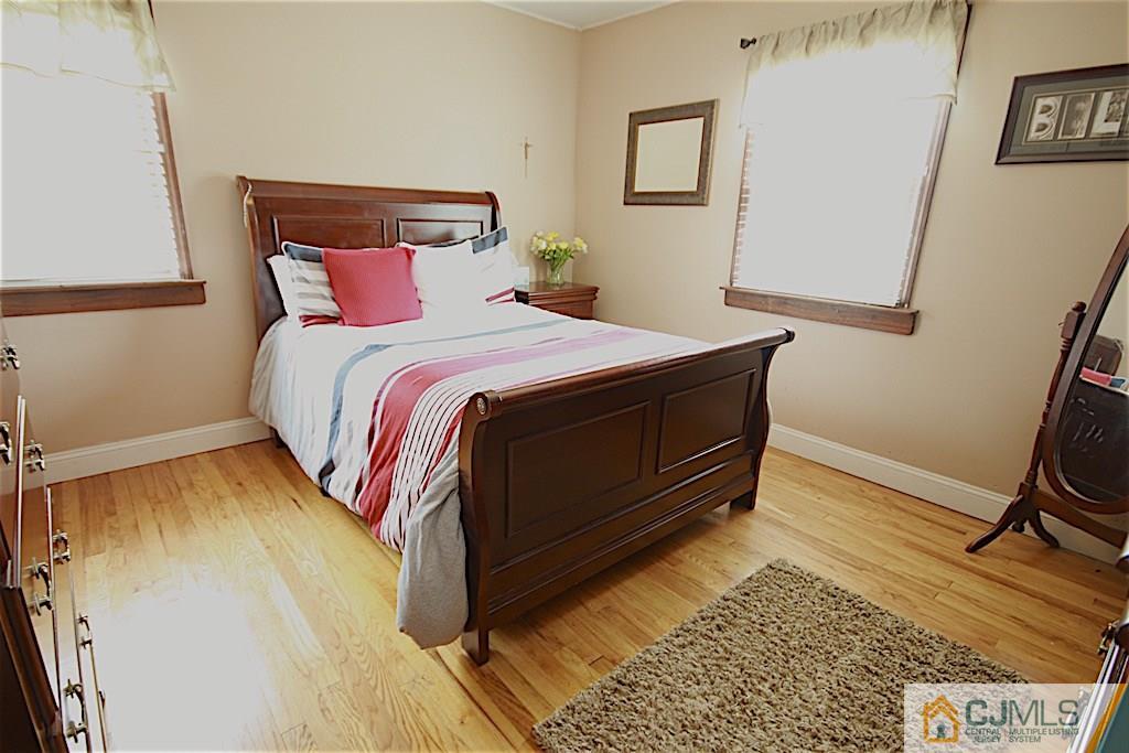 179 Midfield Road Colonia, NJ 07067 - Photo 14 of 18 a bedroom with a bed and wooden floor