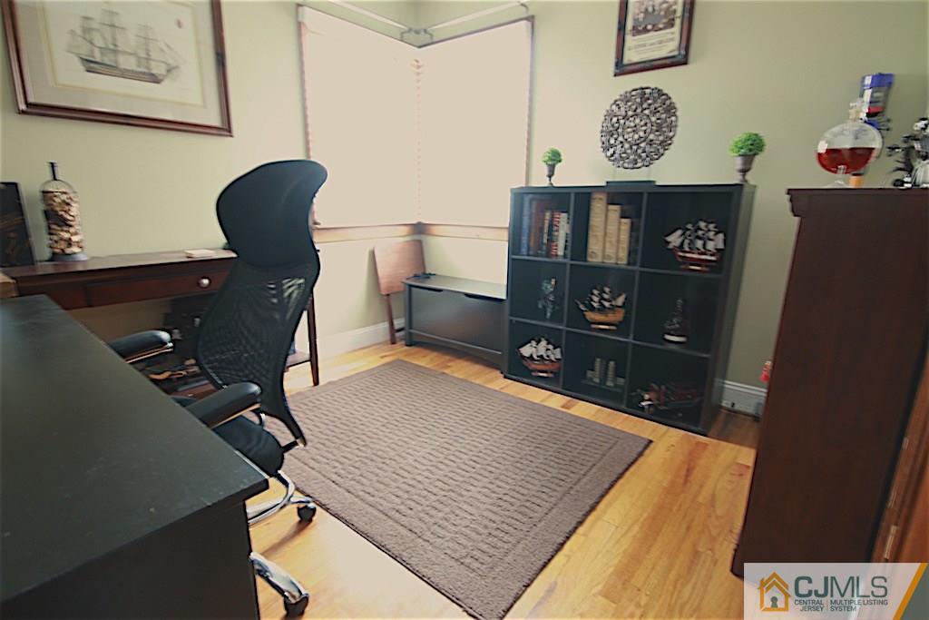 179 Midfield Road Colonia, NJ 07067 - Photo 15 of 18 a room with furniture and wooden floor