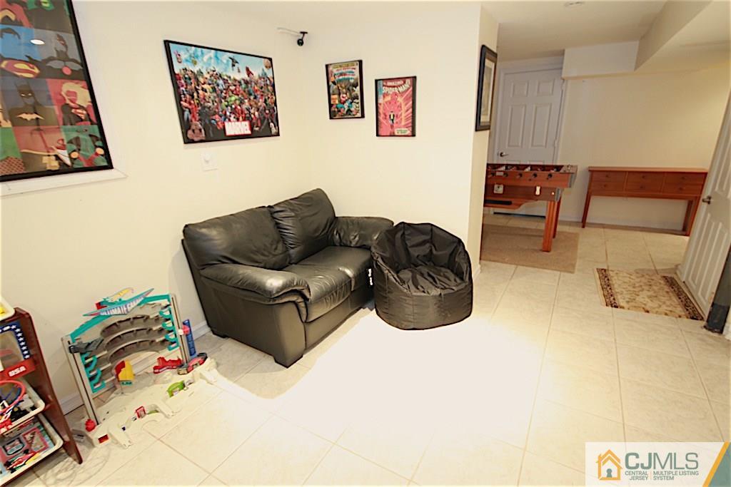 179 Midfield Road Colonia, NJ 07067 - Photo 17 of 18 a living room with furniture rug and couch