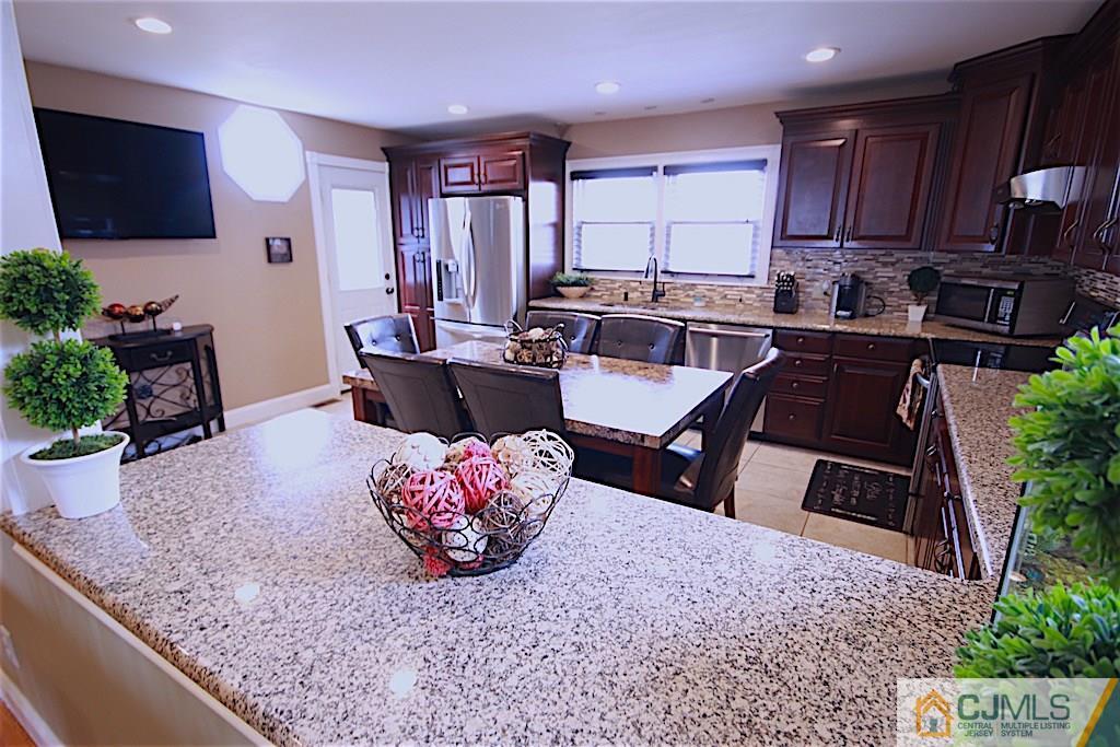 179 Midfield Road Colonia, NJ 07067 - Photo 3 of 18 a kitchen with a table and chairs in it