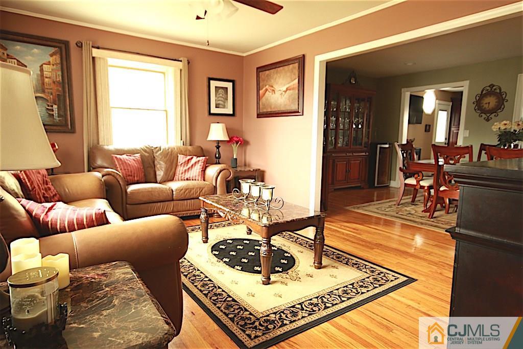 179 Midfield Road Colonia, NJ 07067 - Photo 9 of 18 a living room with furniture a rug and a window