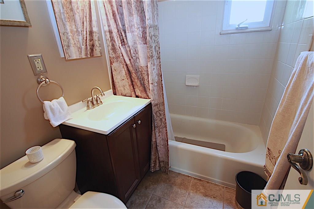 179 Midfield Road Colonia, NJ 07067 - Photo 10 of 18 a bathroom with a sink a toilet and bathtub