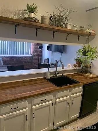 a view of a kitchen with a sink and cabinets