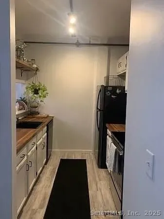 a kitchen with sink and cabinets