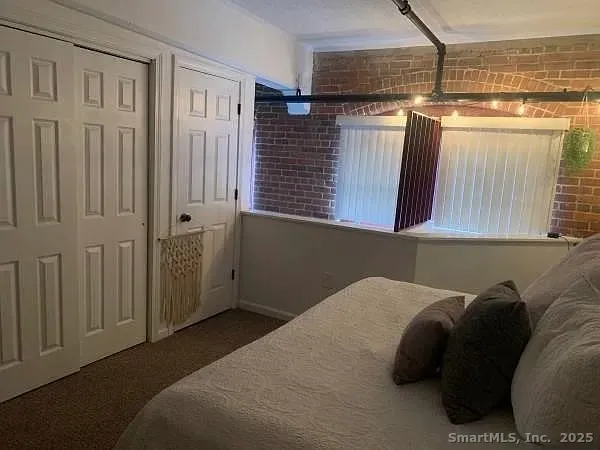 a bed sitting in a bedroom next to a cabinet