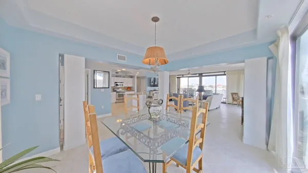 a spacious bedroom with a bed and a chandelier