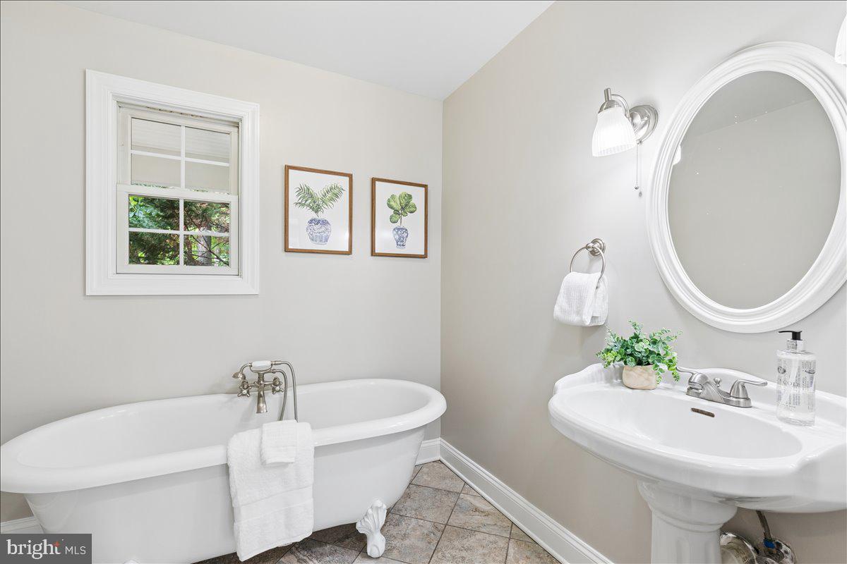 102 Little Neck Road Stevensville, MD 21666 - Photo 37 of 77 a bathroom with a sink and a mirror