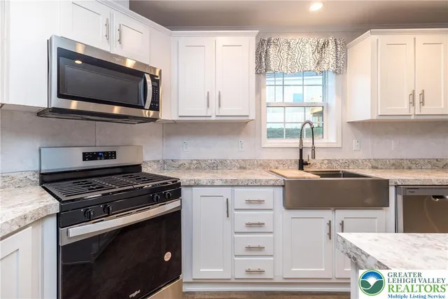 a kitchen with stainless steel appliances a stove a microwave and cabinets