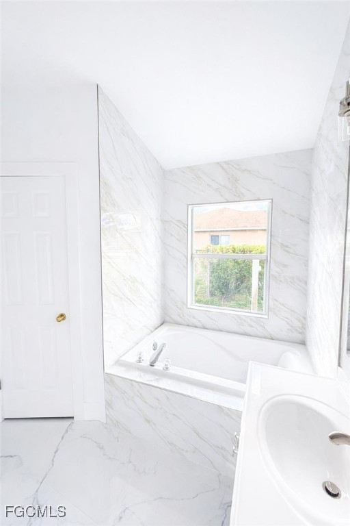 4504 Varsity Circle Lehigh Acres, FL 33971 - Photo 7 of 8 a bathroom with a bathtub and a sink