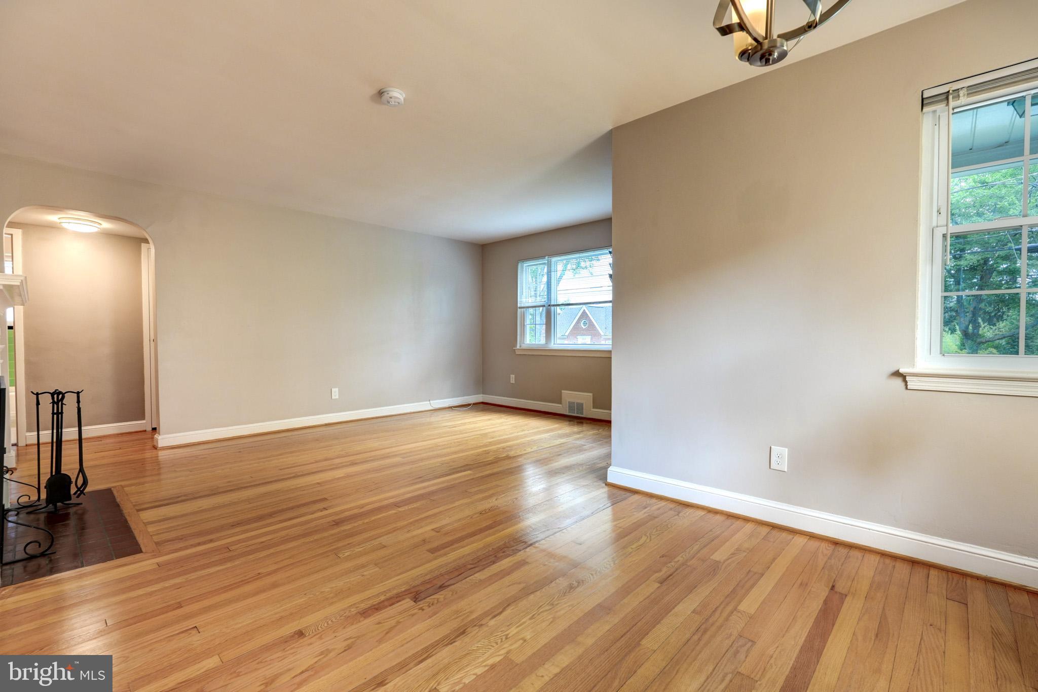 9912 Markham Street Silver Spring, MD 20901 - Photo 11 of 28 wooden floor in an empty room with a window