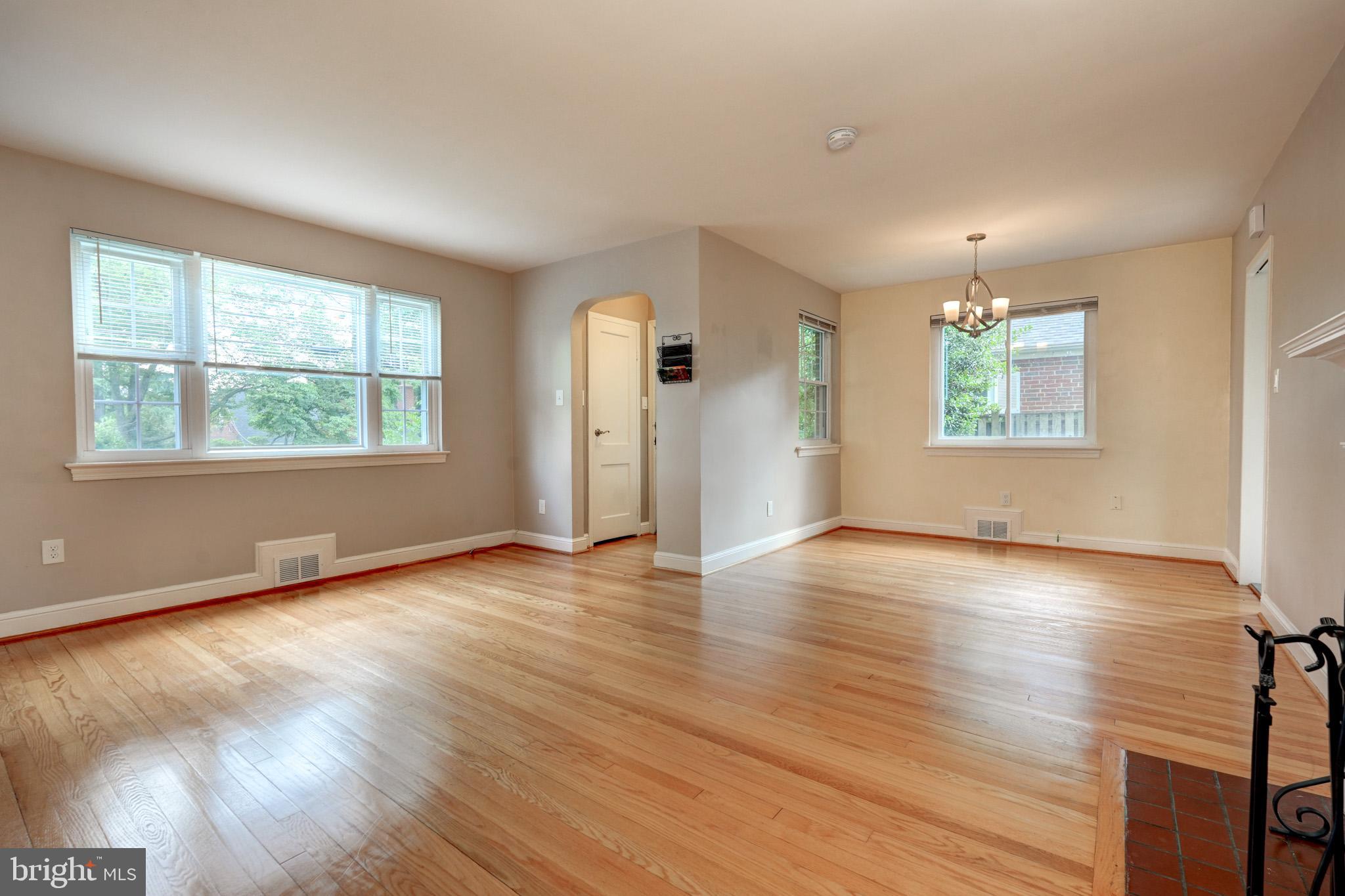 9912 Markham Street Silver Spring, MD 20901 - Photo 12 of 28 an empty room with wooden floor and windows
