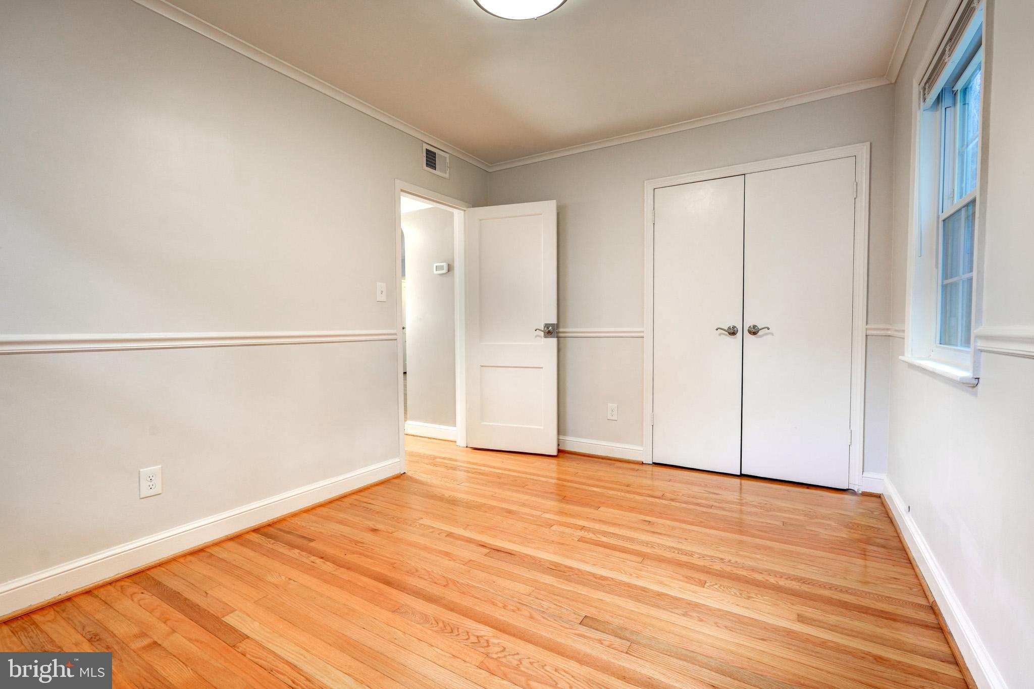 9912 Markham Street Silver Spring, MD 20901 - Photo 15 of 28 a view of an empty room with wooden floor
