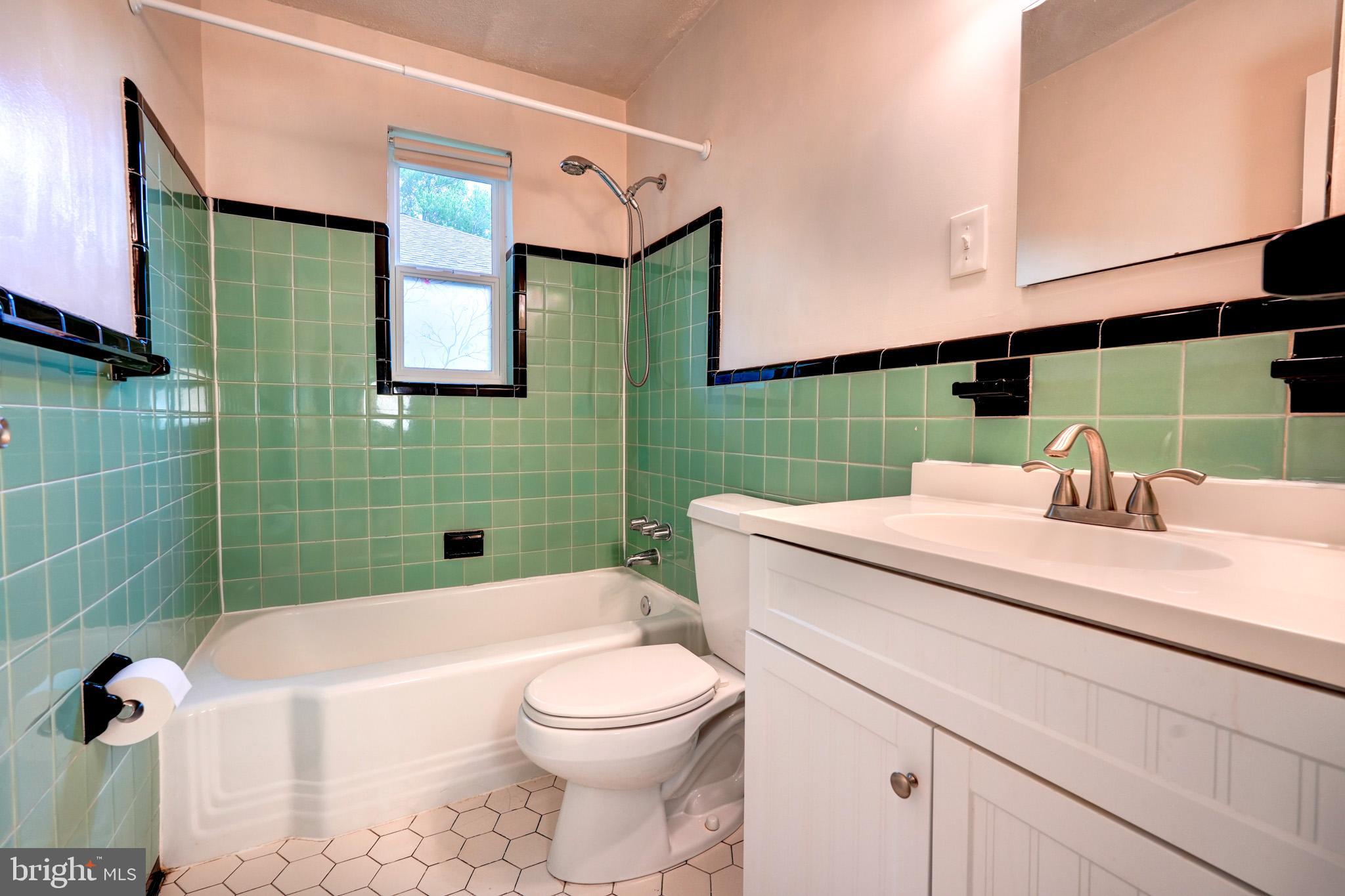 9912 Markham Street Silver Spring, MD 20901 - Photo 16 of 28 a bathroom with a sink a toilet and mirror