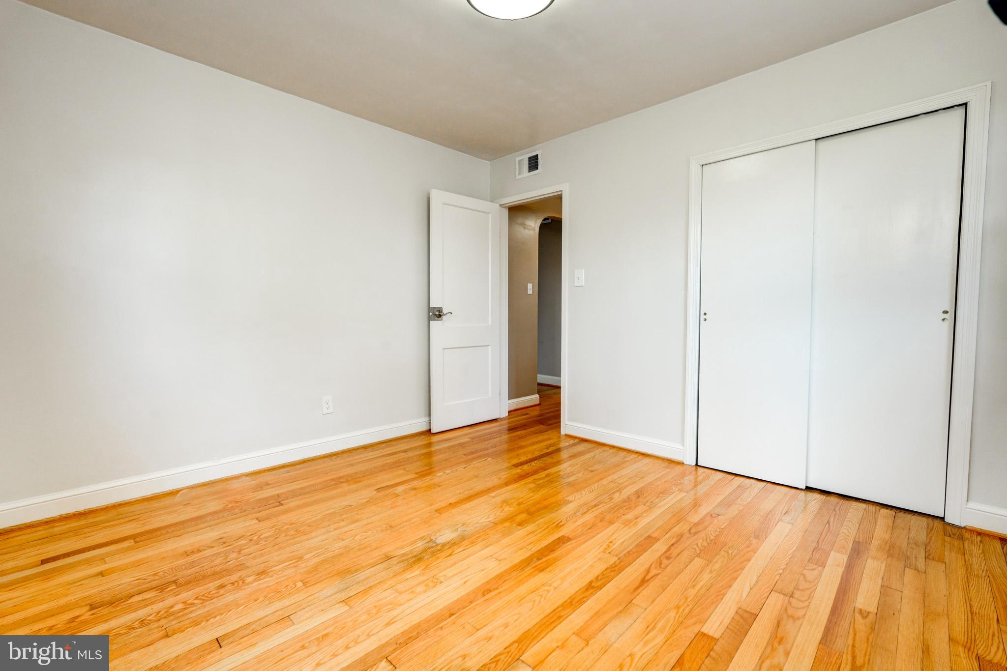 9912 Markham Street Silver Spring, MD 20901 - Photo 19 of 28 a view of an empty room with wooden floor
