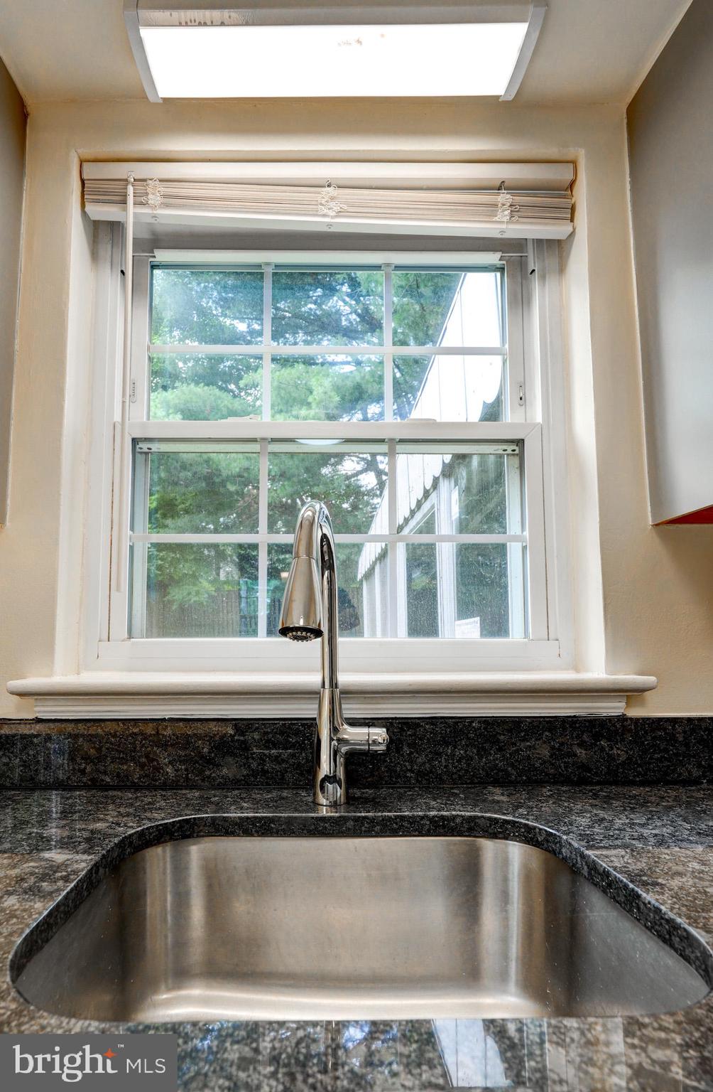 9912 Markham Street Silver Spring, MD 20901 - Photo 25 of 28 a kitchen with a sink a counter top and a window