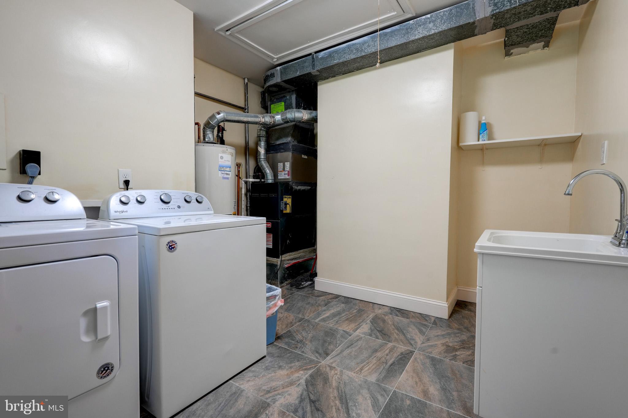 9912 Markham Street Silver Spring, MD 20901 - Photo 27 of 28 a utility room with dryer and washer