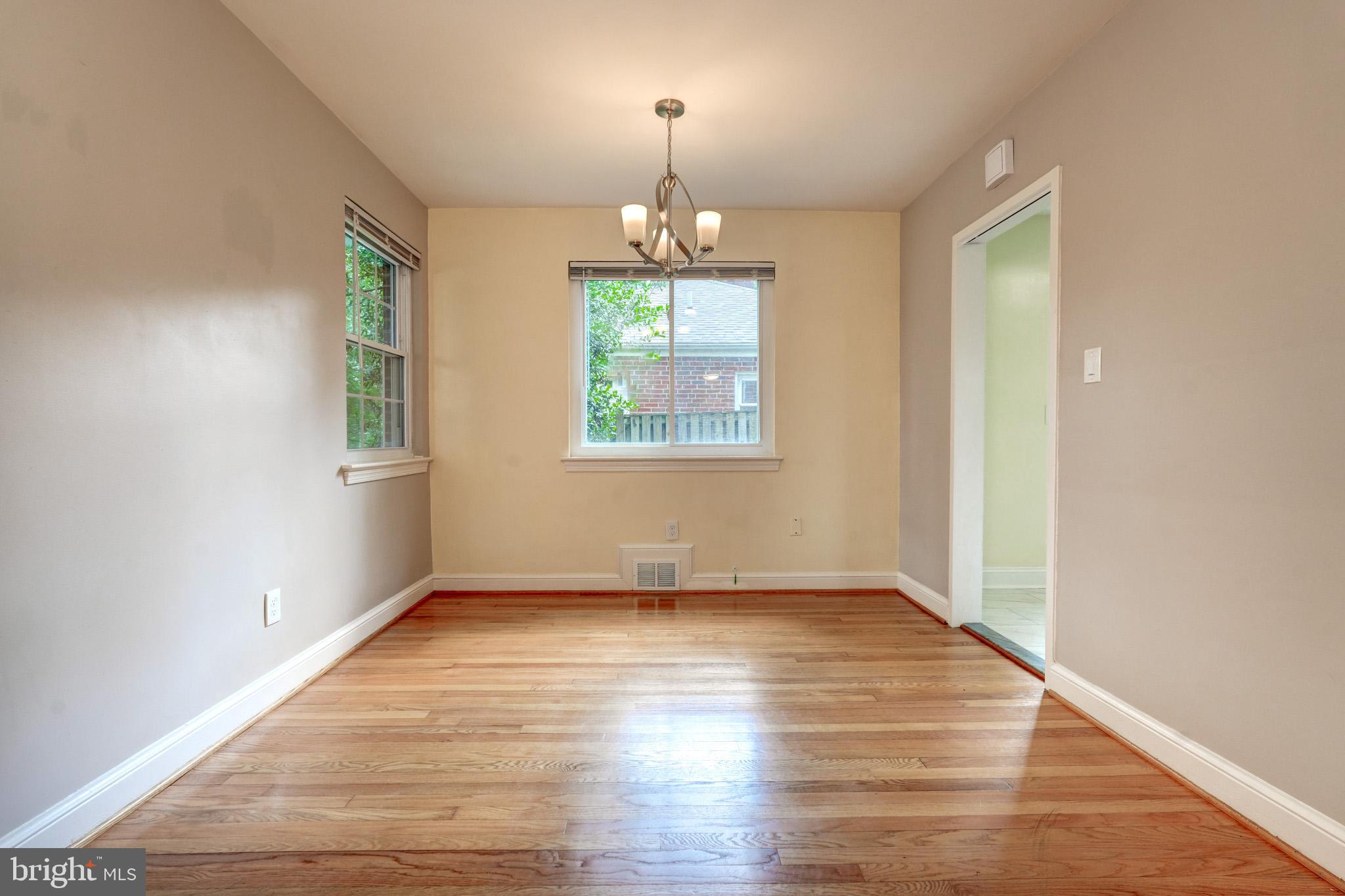 9912 Markham Street Silver Spring, MD 20901 - Photo 8 of 28 a view of an empty room with wooden floor and a window