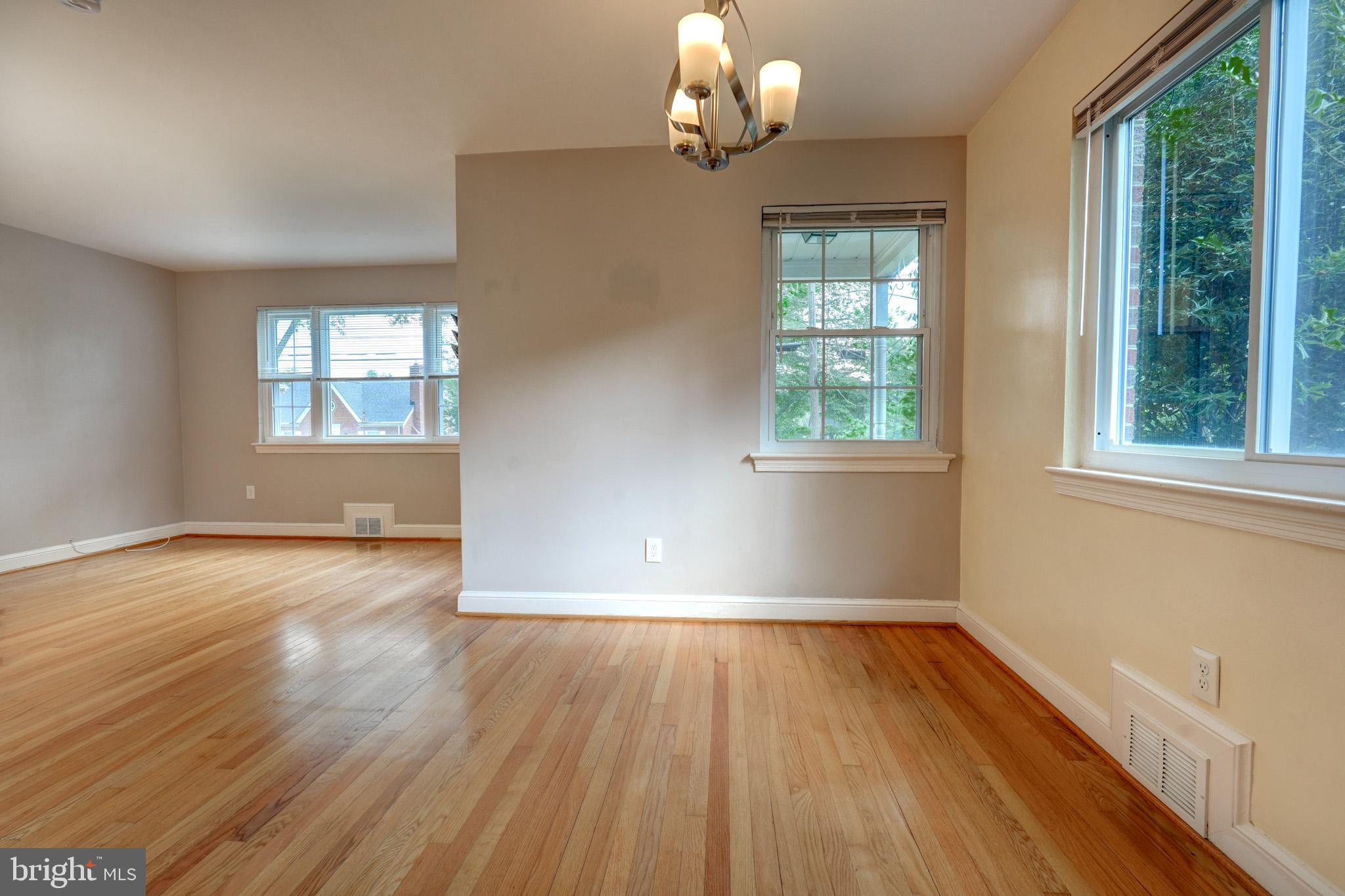 9912 Markham Street Silver Spring, MD 20901 - Photo 9 of 28 an empty room with wooden floor and windows