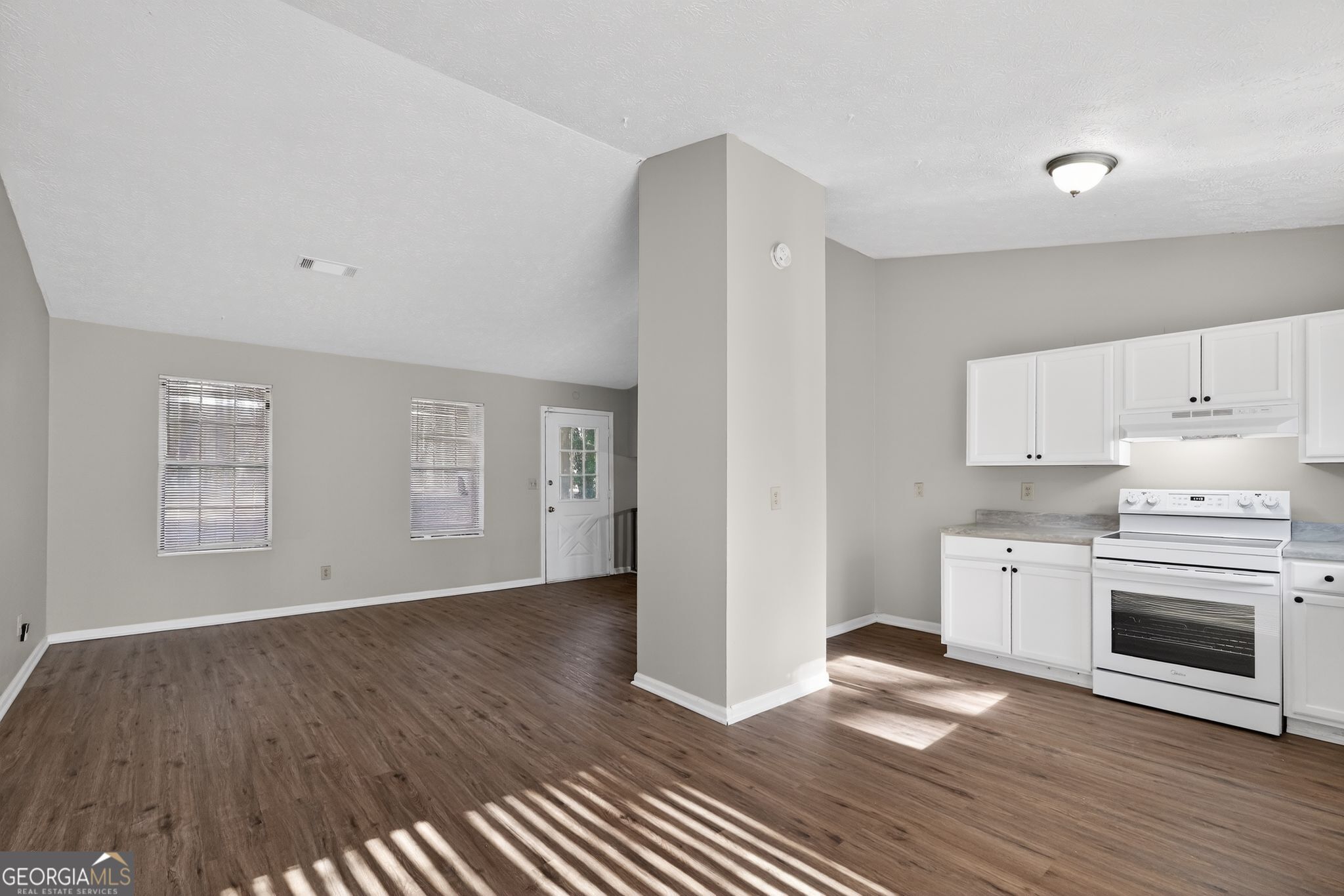 5515 Rock Springs Road Lithonia, GA 30038 - Photo 12 of 34 a view of a kitchen counter space stove wooden floor and window