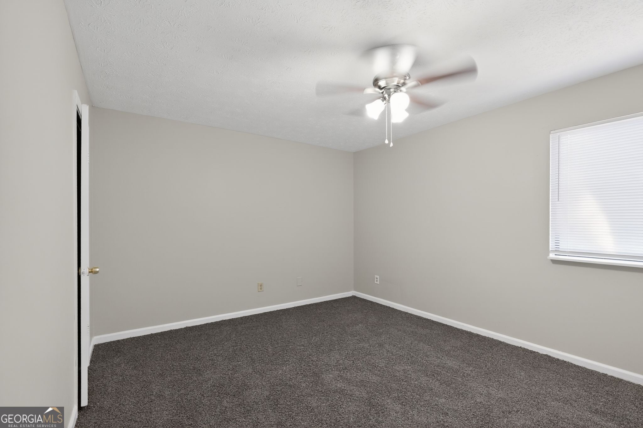 5515 Rock Springs Road Lithonia, GA 30038 - Photo 16 of 34 an empty room with a window and a fan