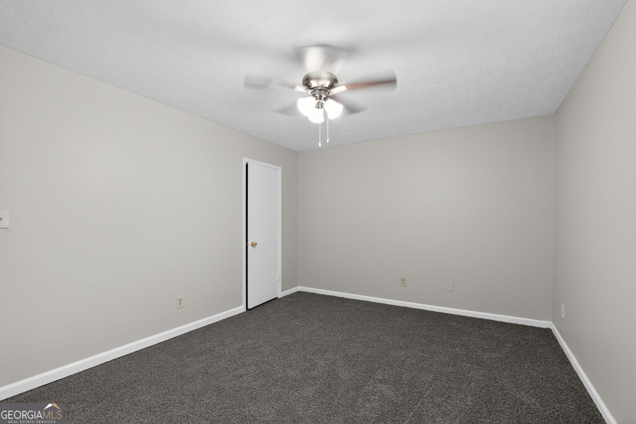 5515 Rock Springs Road Lithonia, GA 30038 - Photo 18 of 34 an empty room with a fan & a ceiling fan