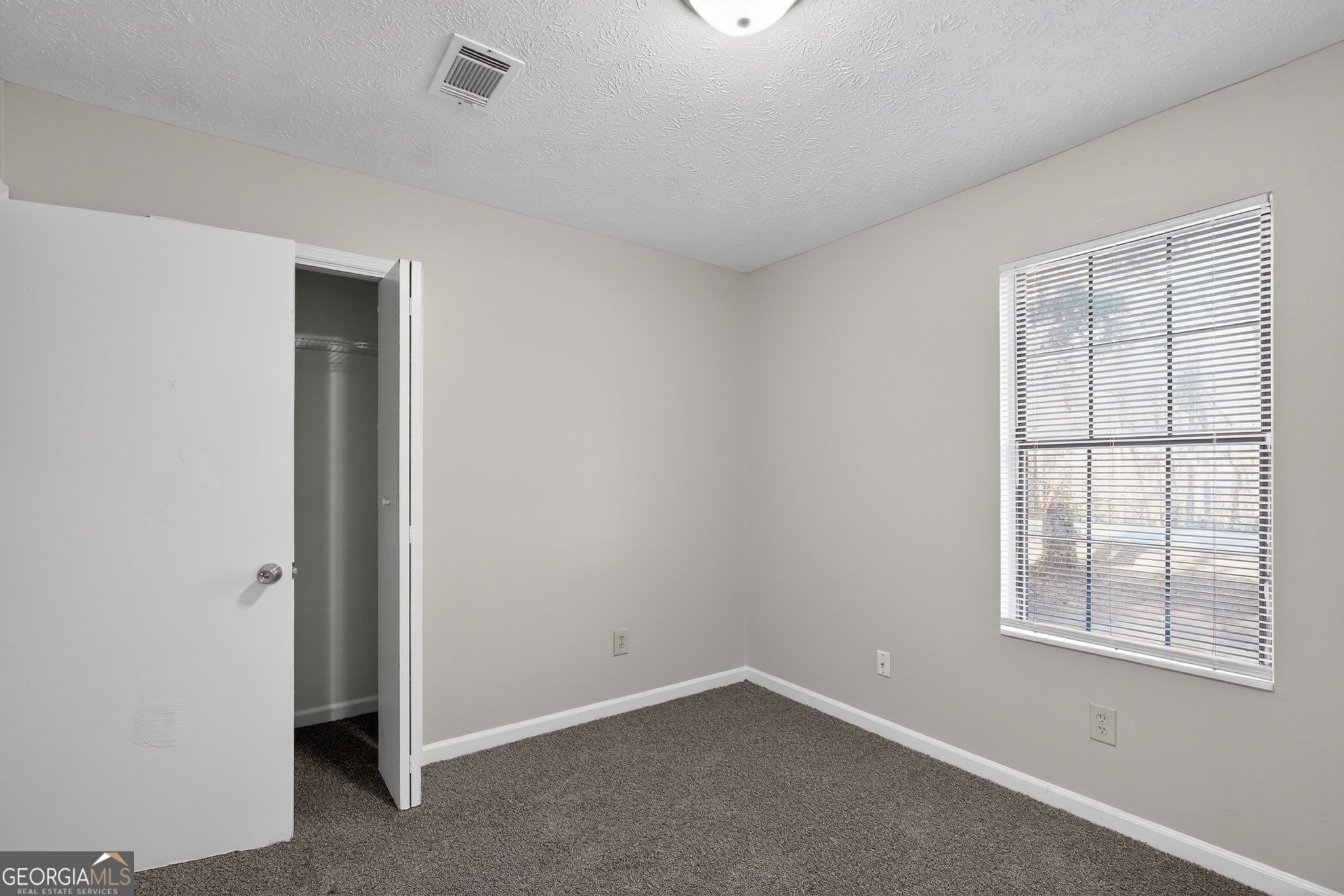 5515 Rock Springs Road Lithonia, GA 30038 - Photo 23 of 34 an empty room with windows