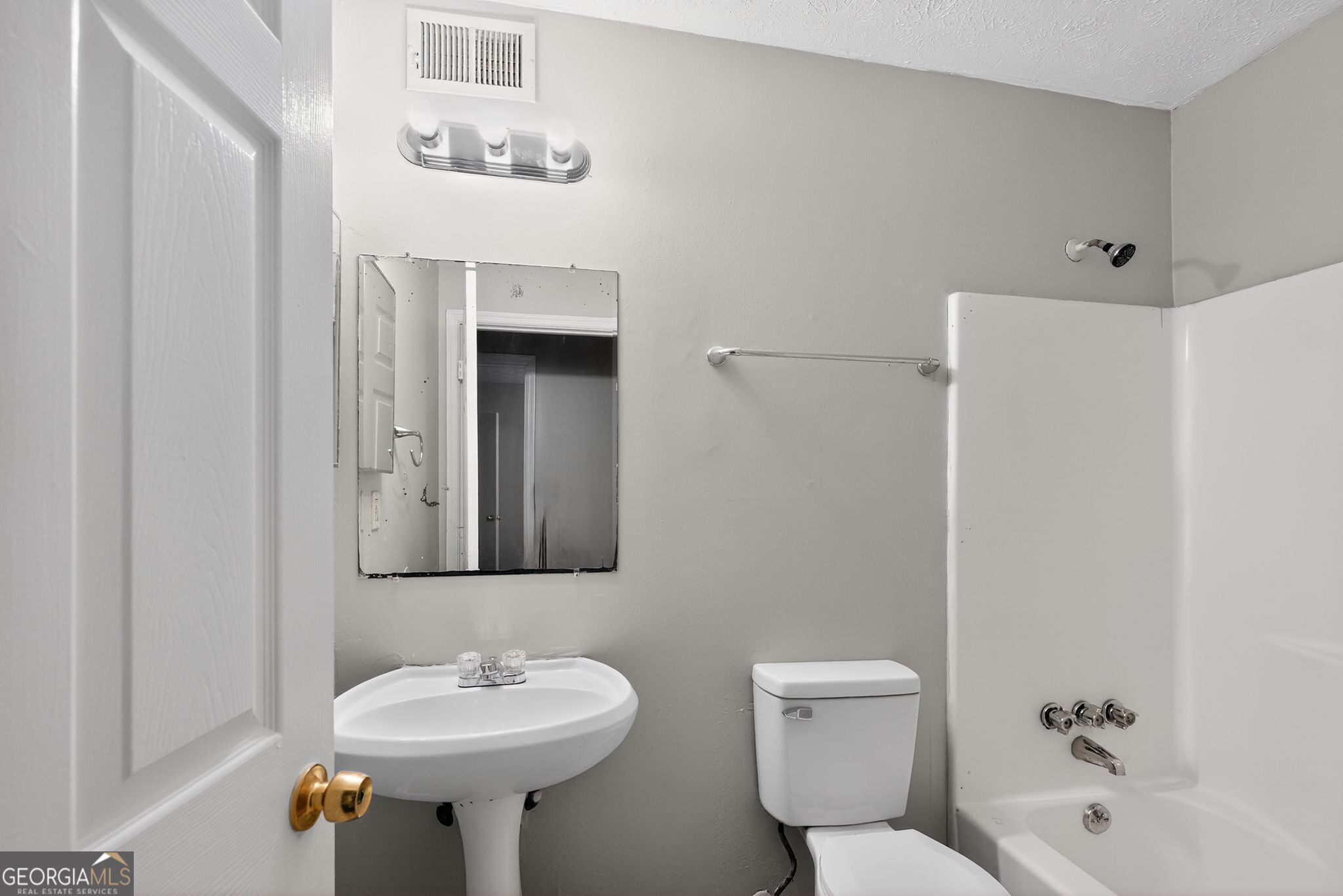 5515 Rock Springs Road Lithonia, GA 30038 - Photo 26 of 34 a bathroom with a sink a toilet and mirror