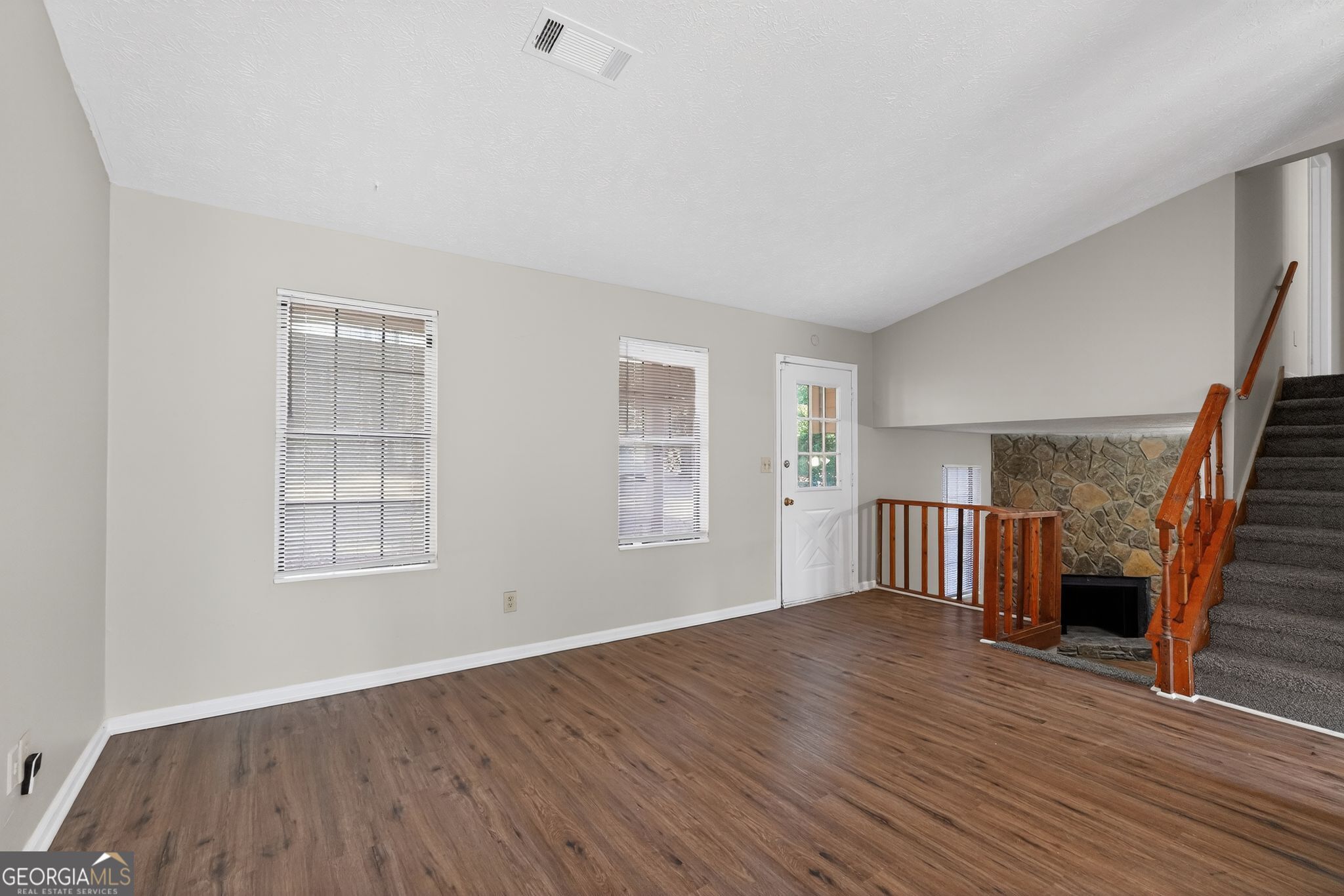 5515 Rock Springs Road Lithonia, GA 30038 - Photo 4 of 34 an empty room with wooden floor and windows