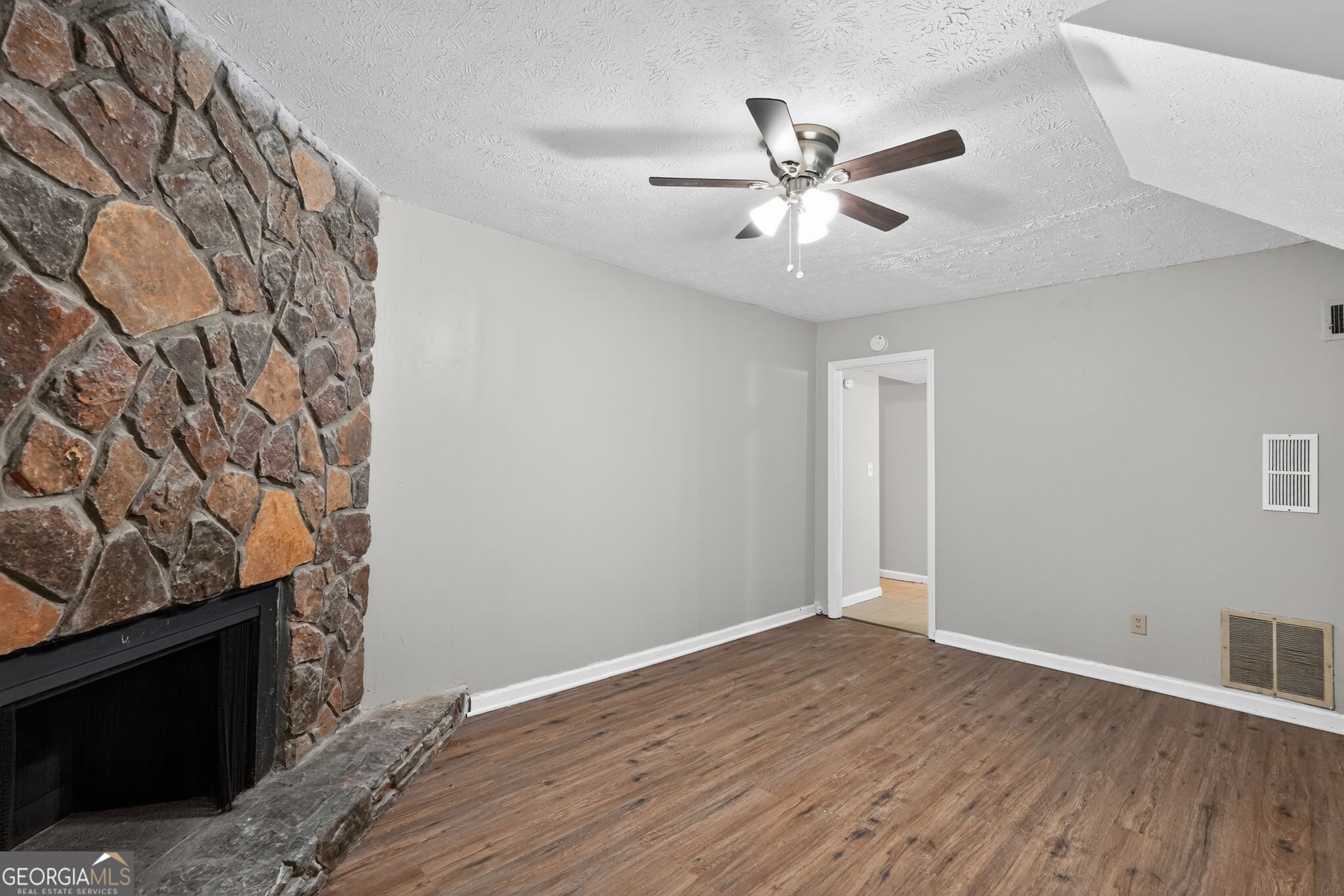 5515 Rock Springs Road Lithonia, GA 30038 - Photo 6 of 34 a view of a livingroom with a ceiling fan and wooden floor