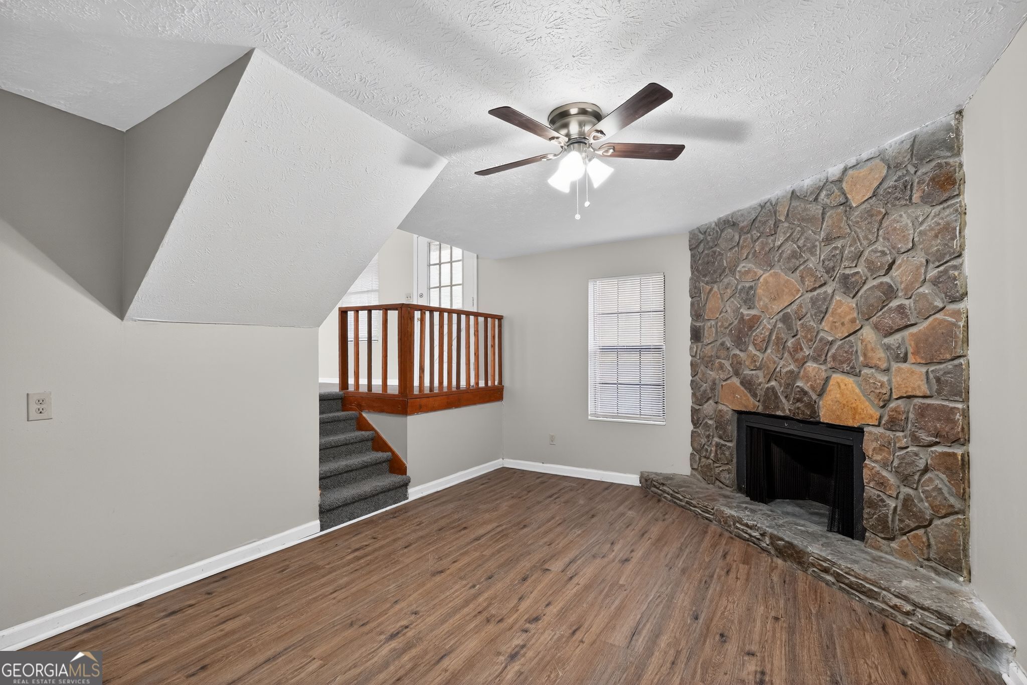 5515 Rock Springs Road Lithonia, GA 30038 - Photo 7 of 34 a view of an empty room with wooden floor and a window