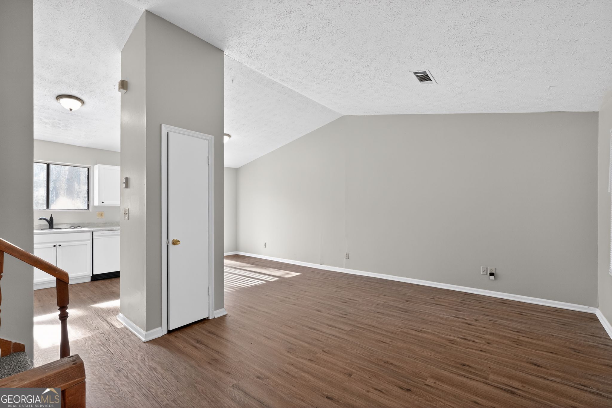 5515 Rock Springs Road Lithonia, GA 30038 - Photo 8 of 34 a view of an empty room with wooden floor and a fireplace