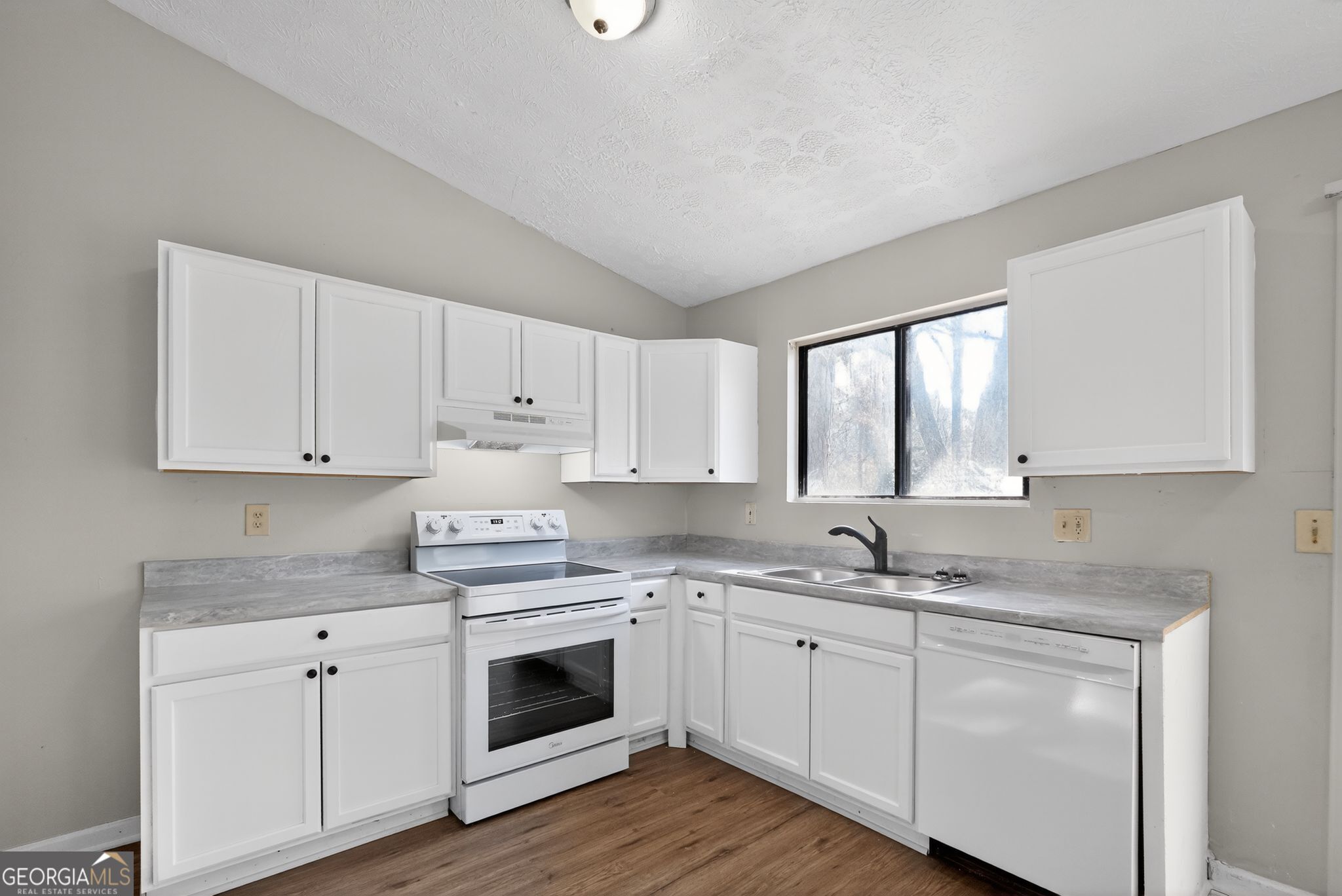 5515 Rock Springs Road Lithonia, GA 30038 - Photo 9 of 34 a kitchen with cabinets appliances a sink and a window