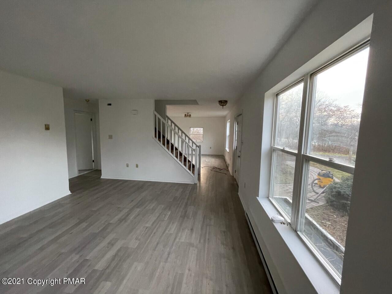 121 Ryan Road Blakeslee, PA 18610 - Photo 6 of 27 a view of a hallway with wooden floor and staircase