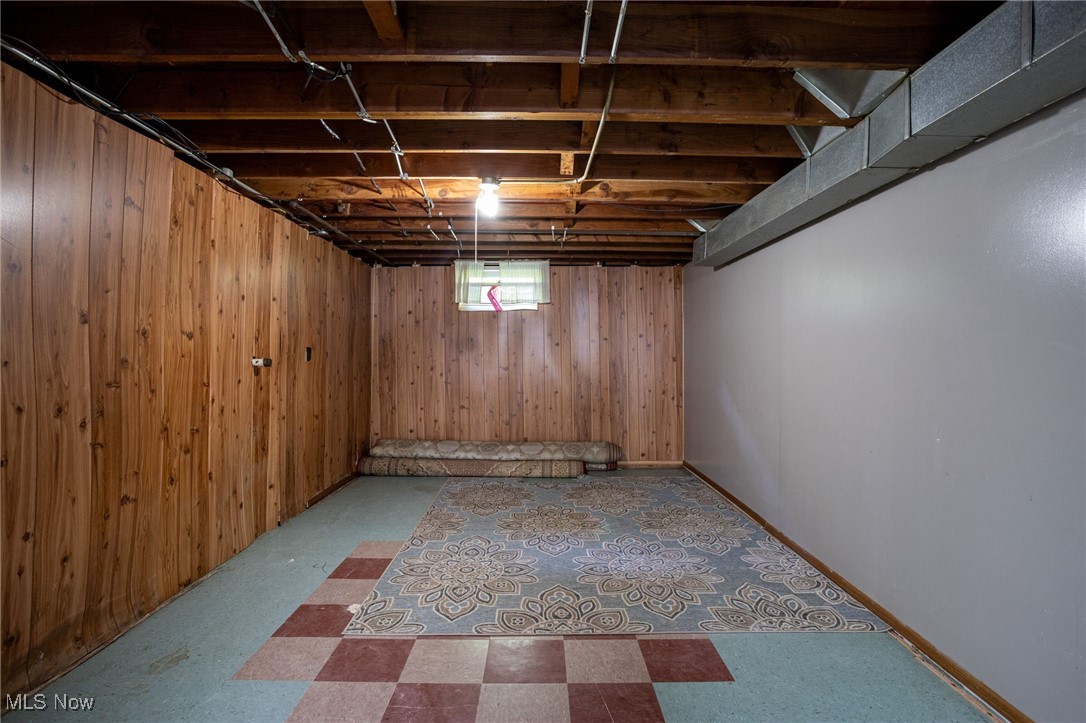 12972 West Sprague Road Cleveland, OH 44130 - Photo 16 of 23 Basement with tile patterned floors and wood walls