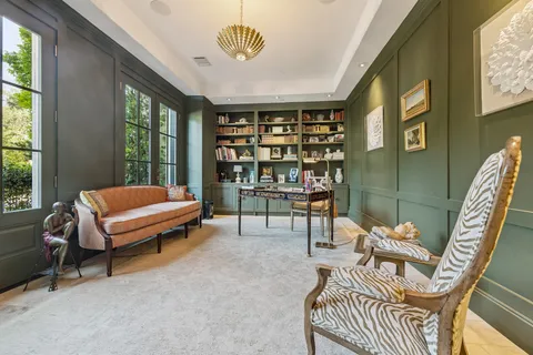 a bedroom with furniture and a large window