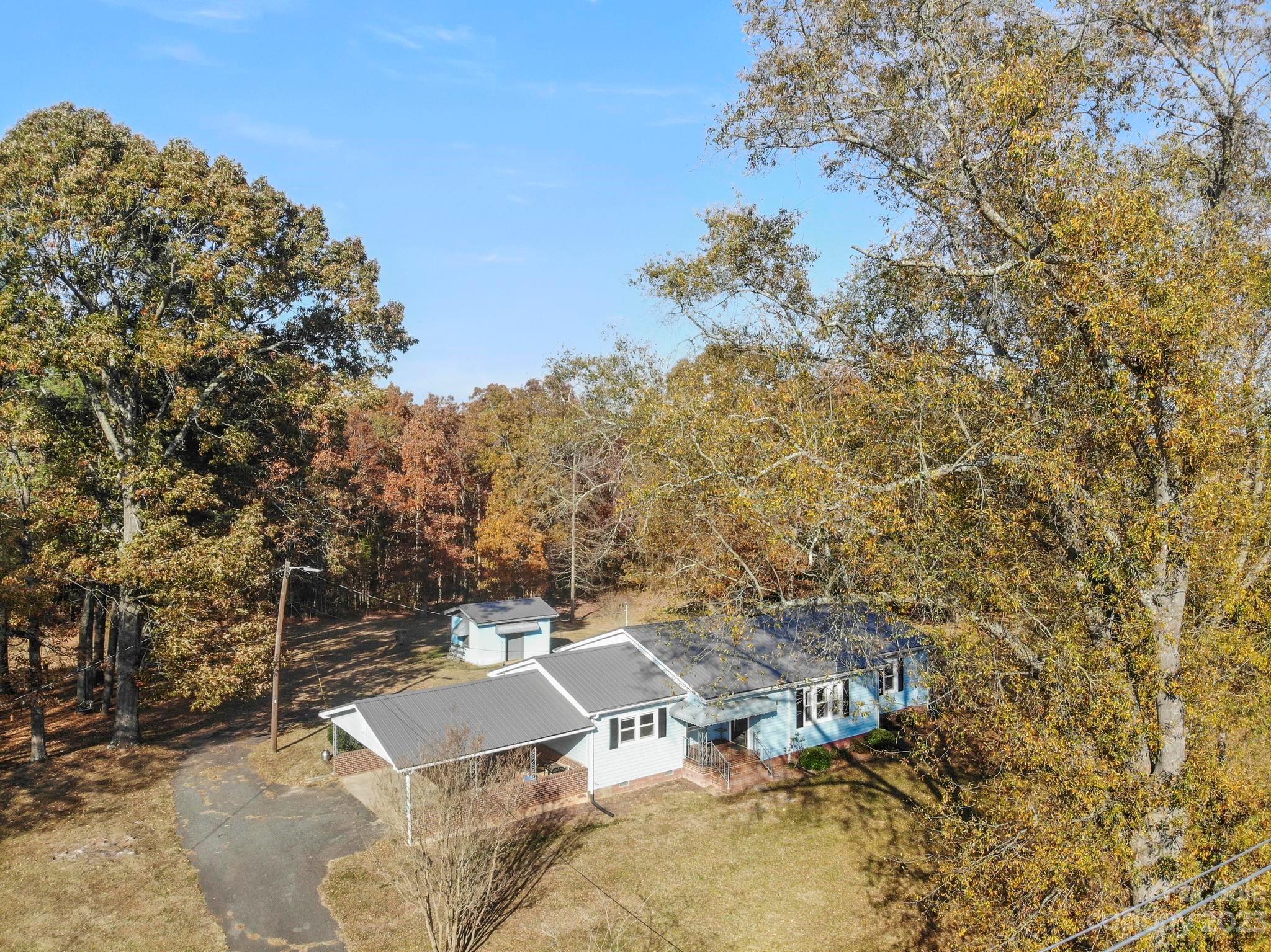aerial view of a house with yard and outdoor seating