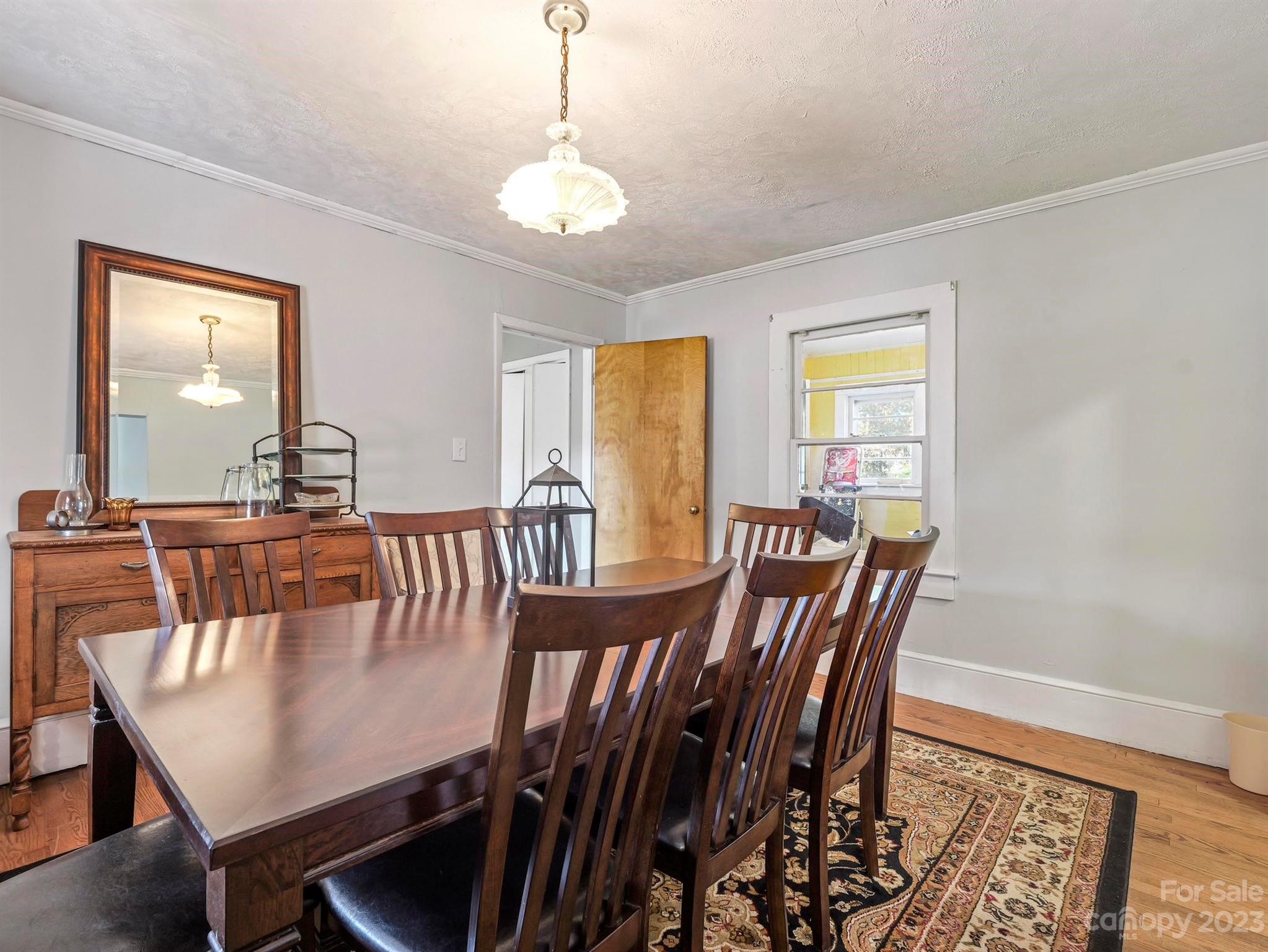 979 High Shoals Church Road Mooresboro, NC 28114 - Photo 21 of 34 a view of a dining room with furniture and wooden floor