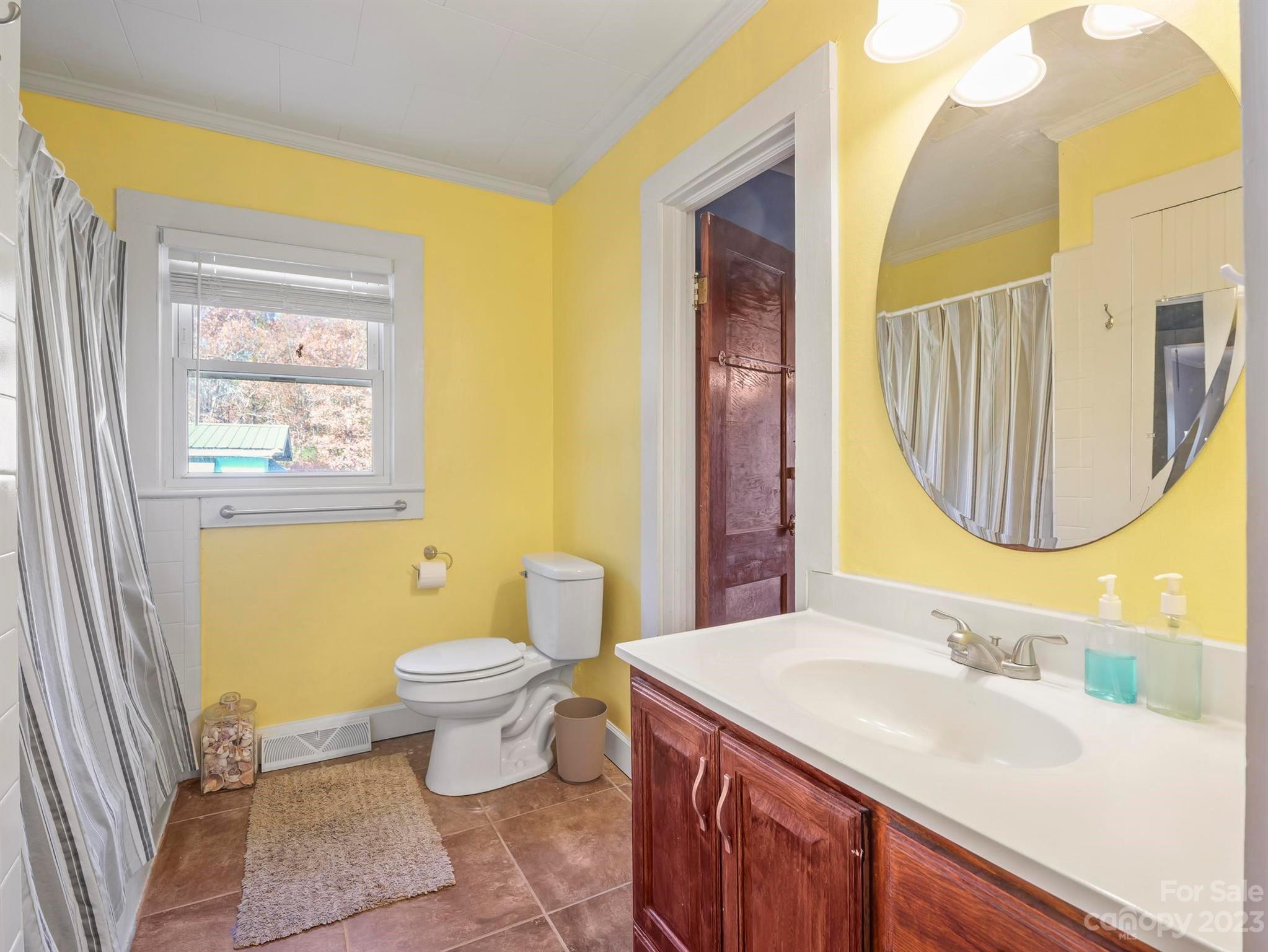 979 High Shoals Church Road Mooresboro, NC 28114 - Photo 25 of 34 a bathroom with a sink a toilet and a mirror