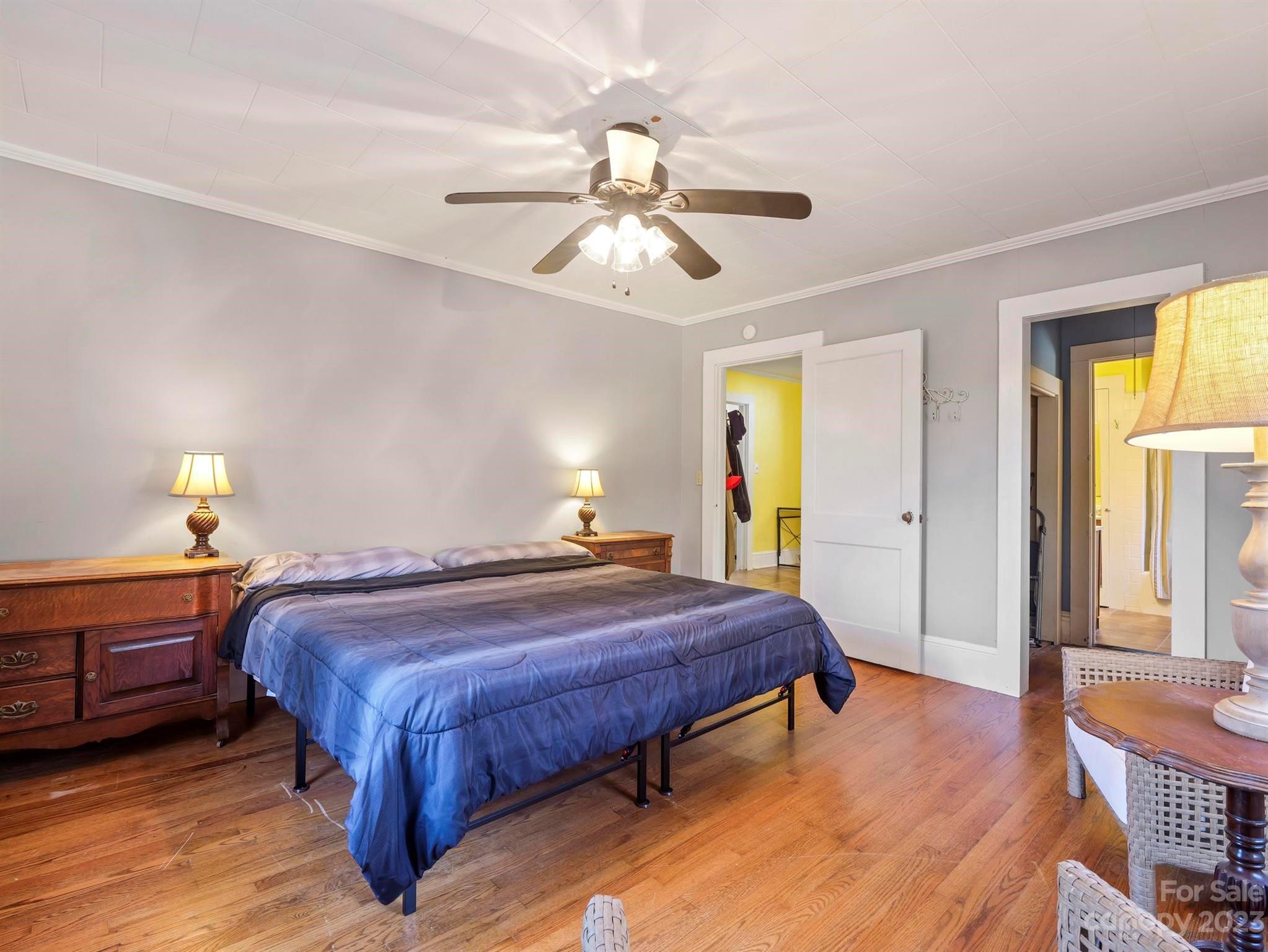 979 High Shoals Church Road Mooresboro, NC 28114 - Photo 28 of 34 a bedroom with a bed and a chandelier