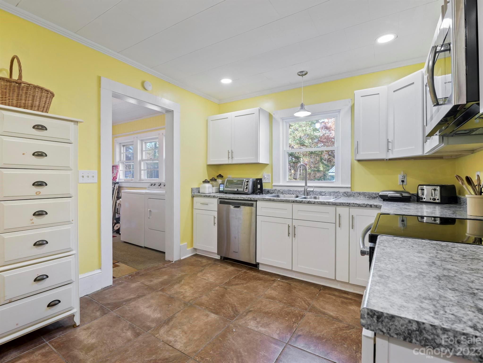 979 High Shoals Church Road Mooresboro, NC 28114 - Photo 29 of 34 a kitchen with a refrigerator and white cabinets