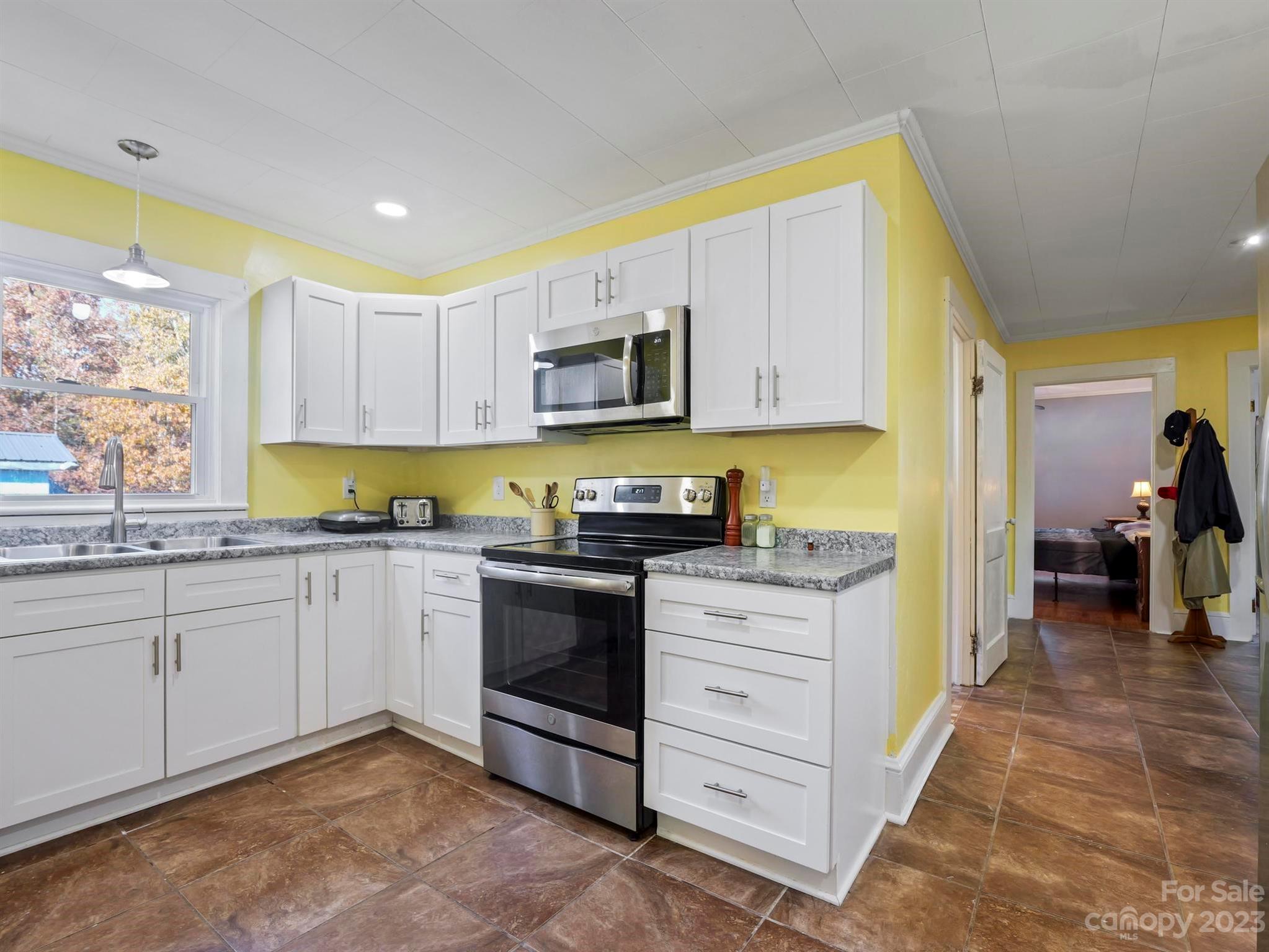 979 High Shoals Church Road Mooresboro, NC 28114 - Photo 30 of 34 a kitchen with granite countertop a sink and cabinets