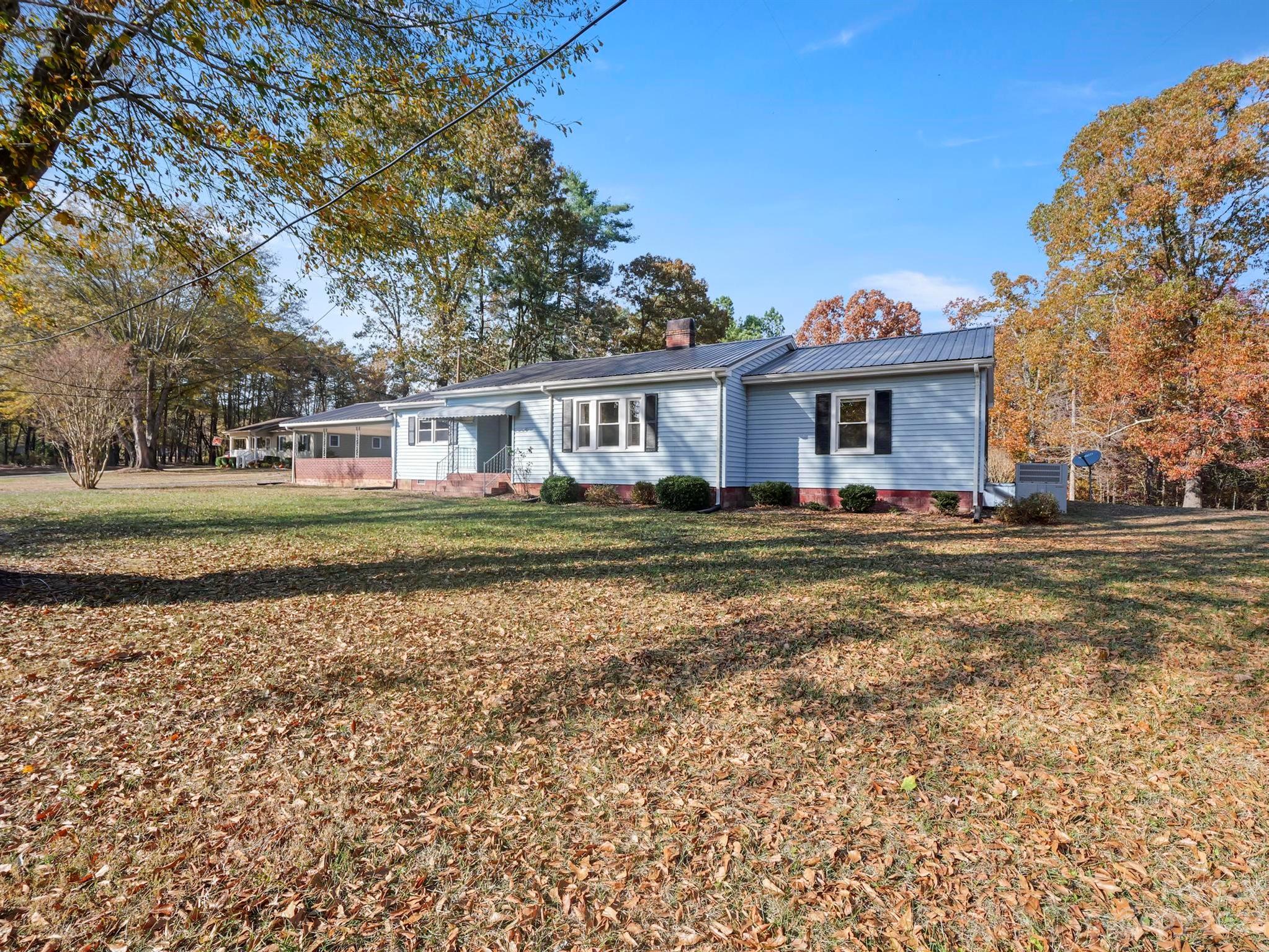 979 High Shoals Church Road Mooresboro, NC 28114 - Photo 3 of 34 a front view of a house with a garden